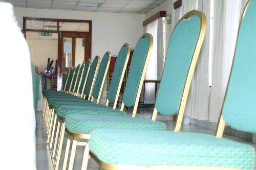 a row of blue chairs in a waiting room at Adventist LMS Guest House & Conference Centre in Nairobi