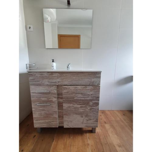 a bathroom with a sink and a mirror at VADOS - LA COLINA in Arnuero