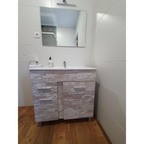 a bathroom with a sink and a mirror at BILOÑA - LA COLINA in Arnuero