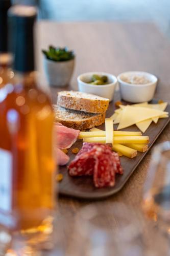 a plate of food with cheese and meats on a table at Kyriad Hotel Laval in Laval