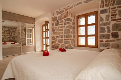 a bedroom with a large bed with red pillows on it at Three Arches in Muo