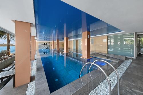 an image of a swimming pool in a house at Occidental Cala Viñas in Cala Vinyes