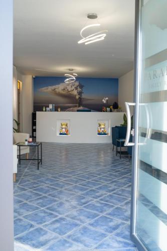 a lobby with a waiting room with blue tiles at Paradise Sicily Rooms in Calatabiano