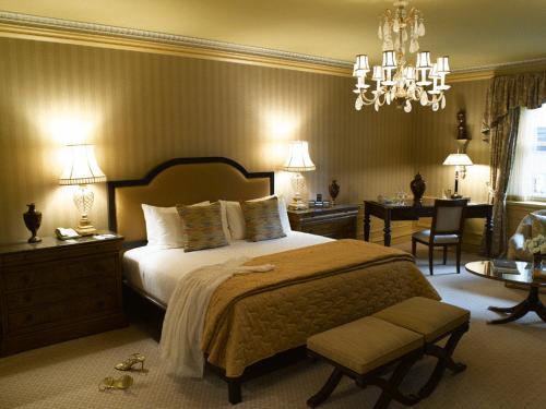 a bedroom with a large bed and a chandelier at The Sherry Netherland in New York