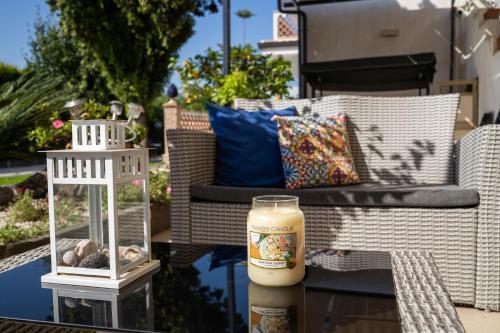 a candle sitting on a table next to a couch at Paradise Sicily Rooms in Calatabiano