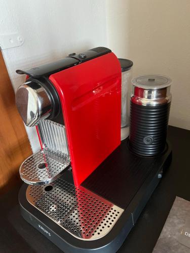 a red mixer sitting on top of a counter at ILION Air Host - near Athens International Airport in Markopoulo