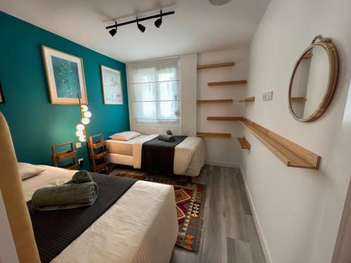 a small room with two beds and a mirror at MedanoJoy1- 3 bedrooms, spacious apartment 60 m from the beach in El Médano