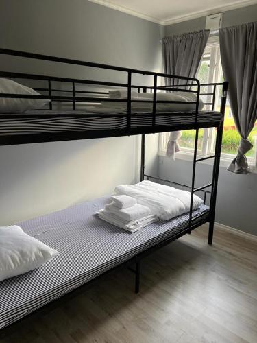 two bunk beds in a room with a window at Källviken Semesterby in Strömstad