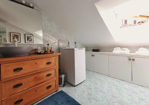 a kitchen with a sink and a refrigerator at Bellagio Retreat lake view apartment in Limonta