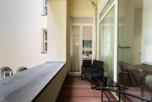 a hallway with a table and chairs in a building at Lunas Appartements in der alten Schule Essen in Essen