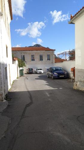 a parking lot with cars parked in front of a building at Sapho's House in Leonidion