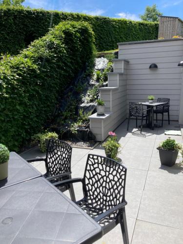 a patio with a table and two chairs and a table and chairs at Ô Secret du Wérihay in Spa