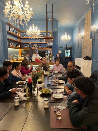 a group of people sitting around a long table at Hotel Restaurante Aconcagua in La Ligua