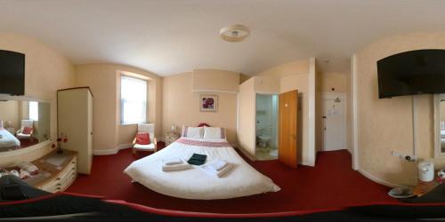 a bedroom with a large bed in a room at Wulfruna Hotel in Paignton