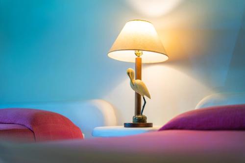 a lamp on a table with a bird on it at Nanajuana Río Dulce in Rio Dulce