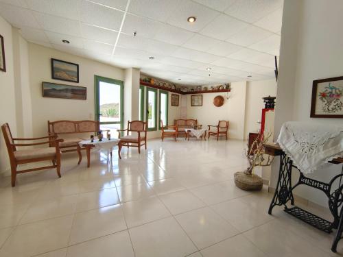 a large room with chairs and tables in a room at Alex in Karpathos Town