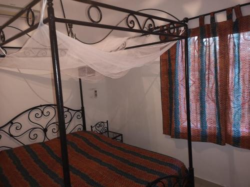 a bedroom with a bunk bed in a room at Keur Baboune in Mbour