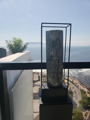 a vase on a balcony with the ocean in the background at Hotel Alto Antofagasta in Antofagasta