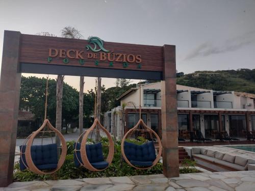 a sign for a hotel with blue chairs in it at Deck de Búzios in Búzios
