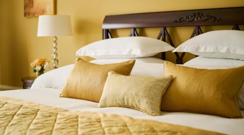 a bedroom with two beds with white pillows at Castlemartyr Resort Hotel in Castlemartyr
