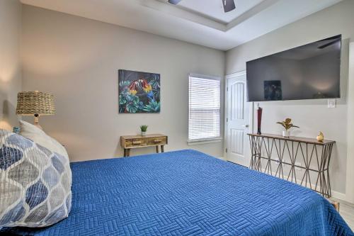 a bedroom with a blue bed and a tv at Gorgeous Edinburg Getaway about 2 Mi to UTRGV! in Edinburg
