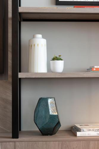 a shelf with a vase and a rock on it at Sheraton Nice in Nice