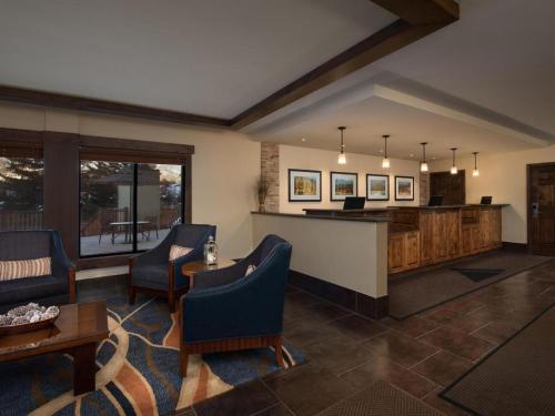 a lobby with a bar and chairs and a table at Aspen at Streamside at Vail in Vail