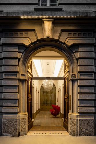 an archway in a building with a red couch at Palazzo Segreti in Milan