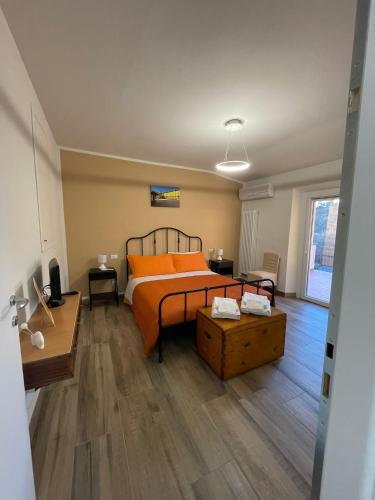 a bedroom with a bed with orange pillows on it at Sassaia11 in Arezzo