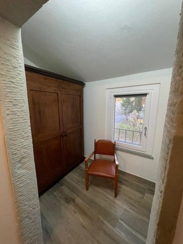 an empty room with a chair and a window at Sassaia11 in Arezzo