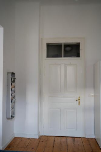 a white door with a window in a white room at Ferienwohnung Sandwirtin in Schwanberg