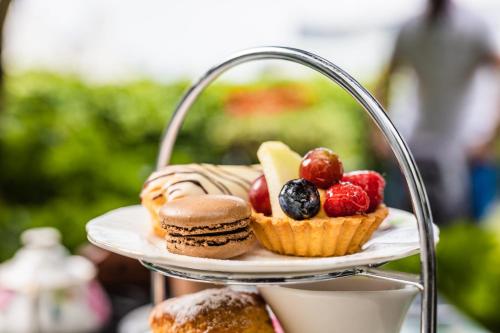 a plate of muffins and pastries on a tray at The Old Government House Hotel & Spa in St Peter Port