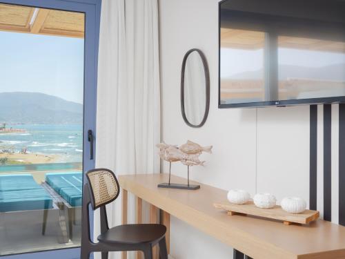 a room with a desk with a view of the ocean at Pyrgos Blue in Malia