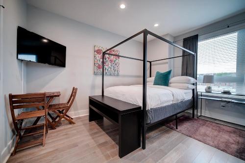 a bedroom with a canopy bed and a desk at Artsy Hidden Gem ll -Free Parking -- in Philadelphia