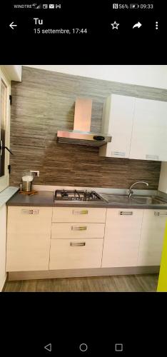 a kitchen with a sink and a stove top oven at Casa Nunna in Palma di Montechiaro