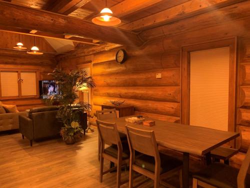 a dining room with a table and chairs at Ruby's Resort & RV Castle Log House in Medical Lake