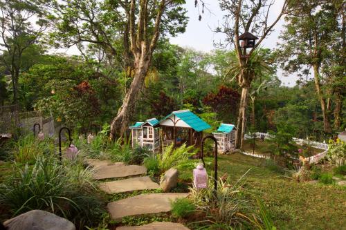 a garden with a play house and a path at Novus Giri Resort & Spa in Puncak