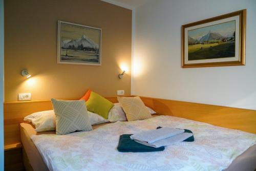 1 dormitorio con 1 cama con 2 toallas en Apartment Alpea, en Bovec