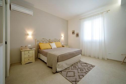 sypialnia z łóżkiem, komodą i oknem w obiekcie Villa Machri - Con Piscina Privata E Ampio Giardino Vicina Al Mare w mieście Gagliano del Capo