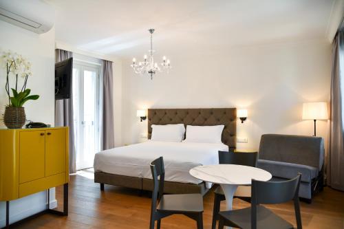 A bed or beds in a room at Sempione Boutique Hotel