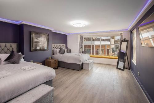 a hotel room with two beds and a window at Town View Apartment by Sasco in Blackpool