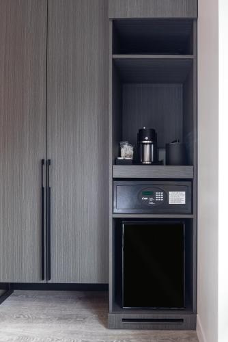 a kitchen with a black oven and a cabinet at Hyatt Centric Charlotte SouthPark in Charlotte