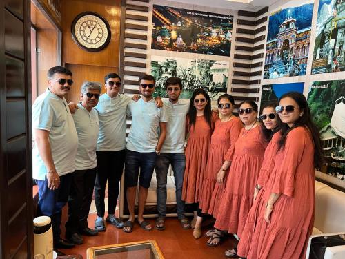 a group of people posing for a picture in a room at Hotel Krishna Ji in Haridwār
