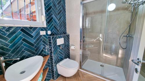 a bathroom with a shower and a toilet and a sink at Apt - Villa Sambije with swimming pool, Dobrec - Opatija in Dobreć