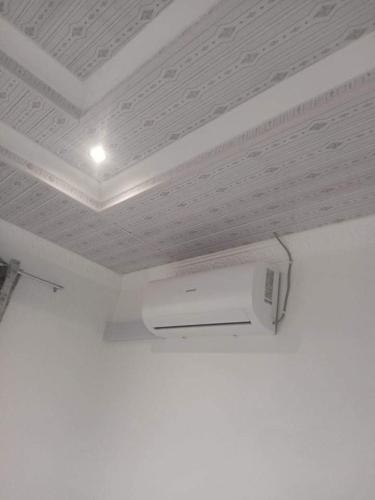 a room with a white ceiling and a white object at Jayla Homestay in Maun