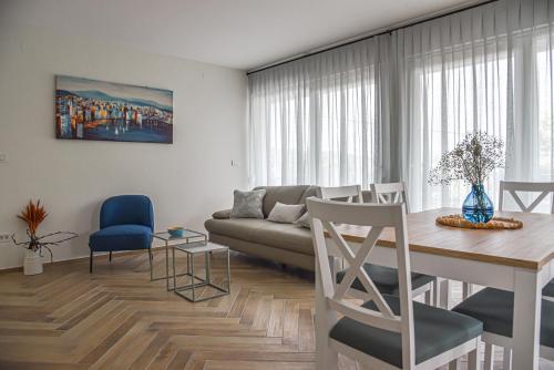 a living room with a couch and a table at Apt - Villa Sambije with swimming pool, Dobrec - Opatija in Dobreć