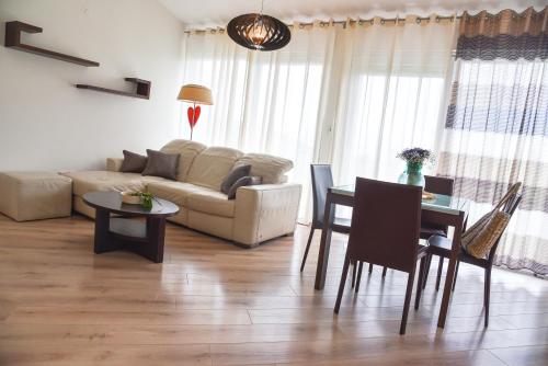 a living room with a couch and a table at Apt - Villa Sambije with swimming pool, Dobrec - Opatija in Dobreć