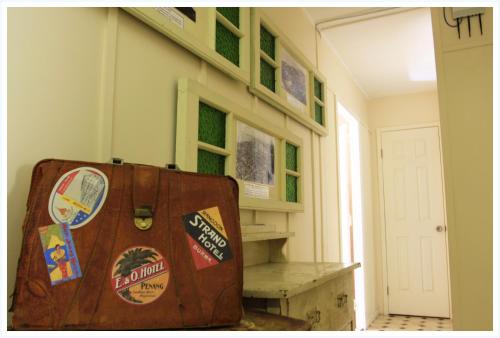 a suitcase sitting in a room with a stair case at Coral Lodge Bed and Breakfast Inn in Townsville