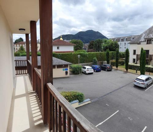 a balcony with cars parked in a parking lot at Appartement de l'Isard Bleu, dans résidence de tourisme 3 étoiles in Lourdes