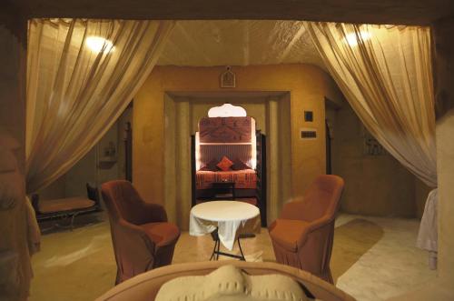 a room with a bed and a table and chairs at Ajit Bhawan - A Palace Resort in Jodhpur